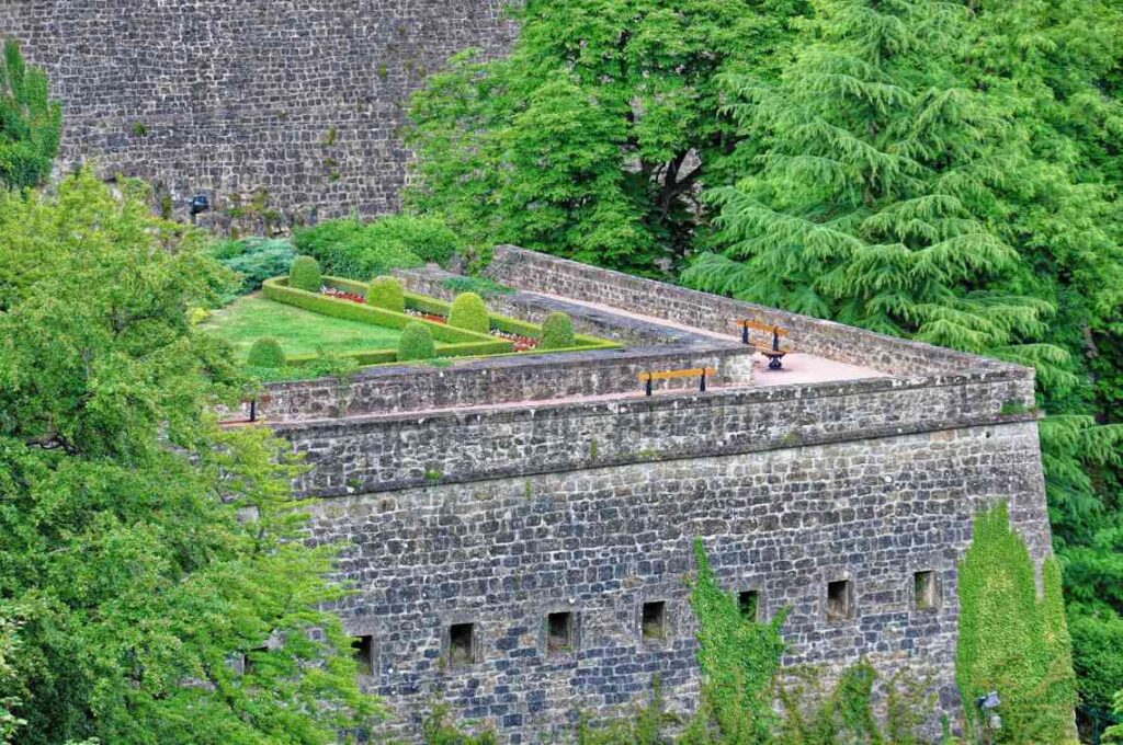 portion of stone bock casemates in luxembourg, with benches and greenery