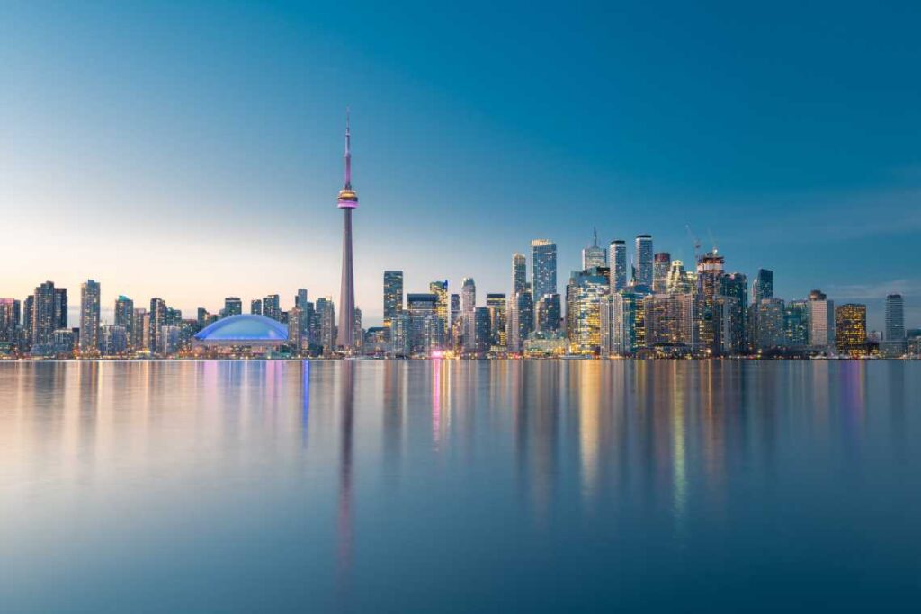 Skyline of Toronto at sunset with reflections on the water