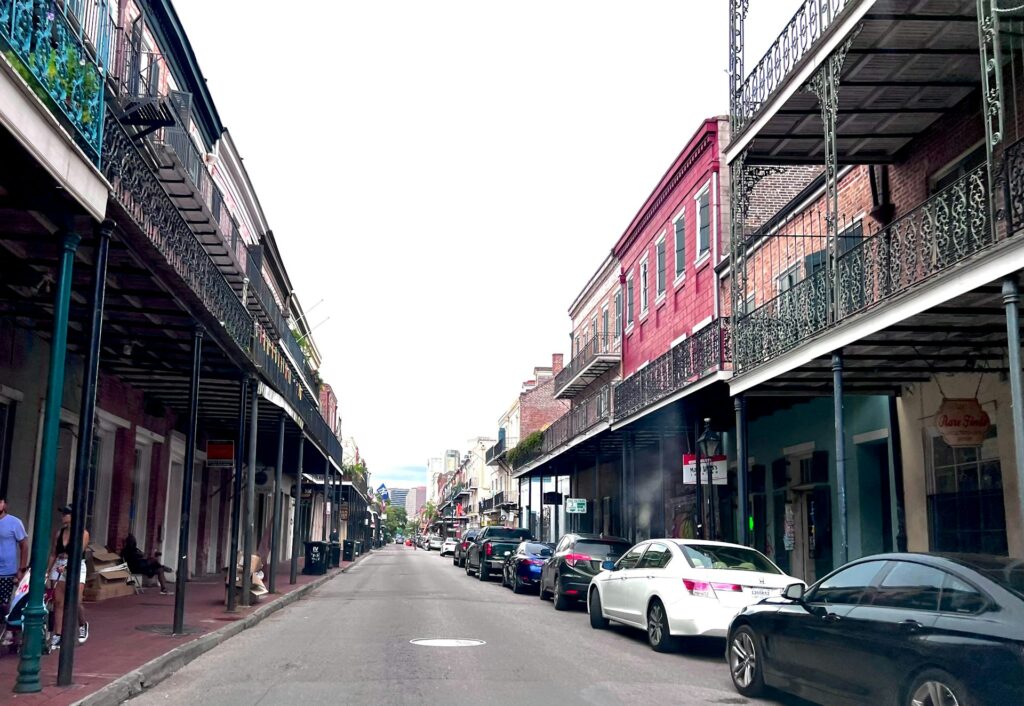 A city street in New Orleans with lots of parked cars.