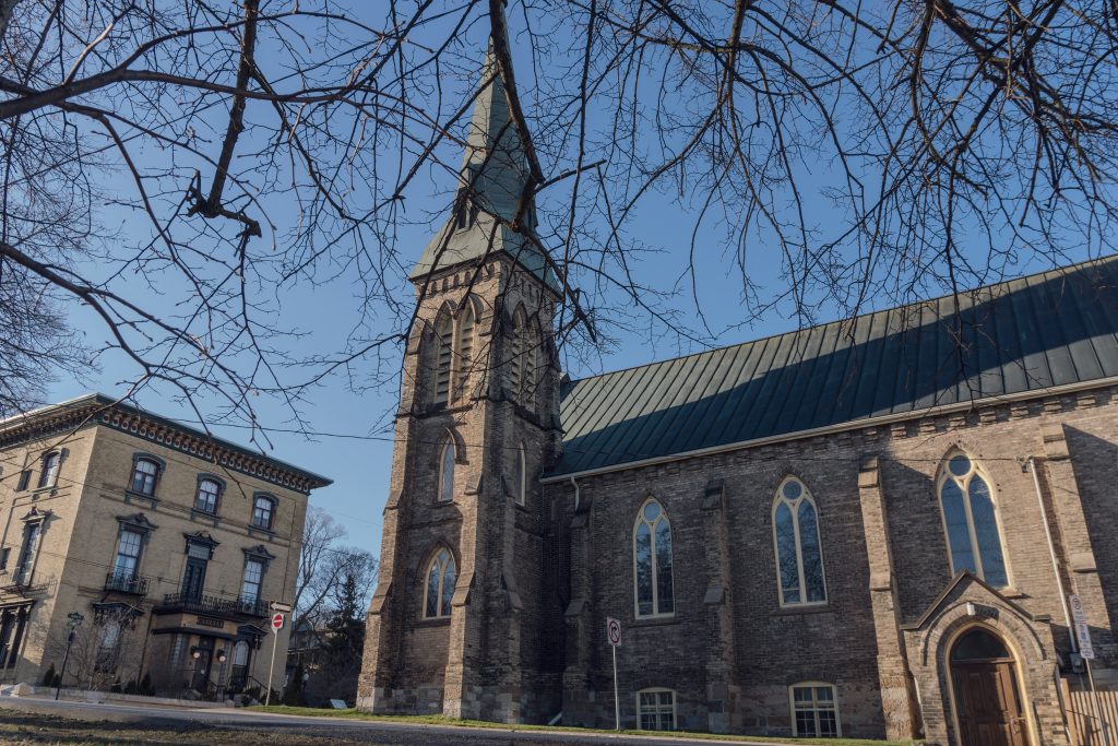 A historic stone church with a tall steeple in Port Hope, Ontario.
