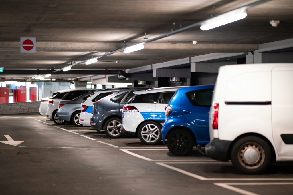 Cars parked in a covered parking garage.