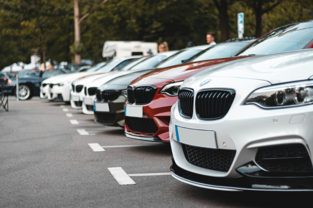 A row of cars parked in a parking lot.