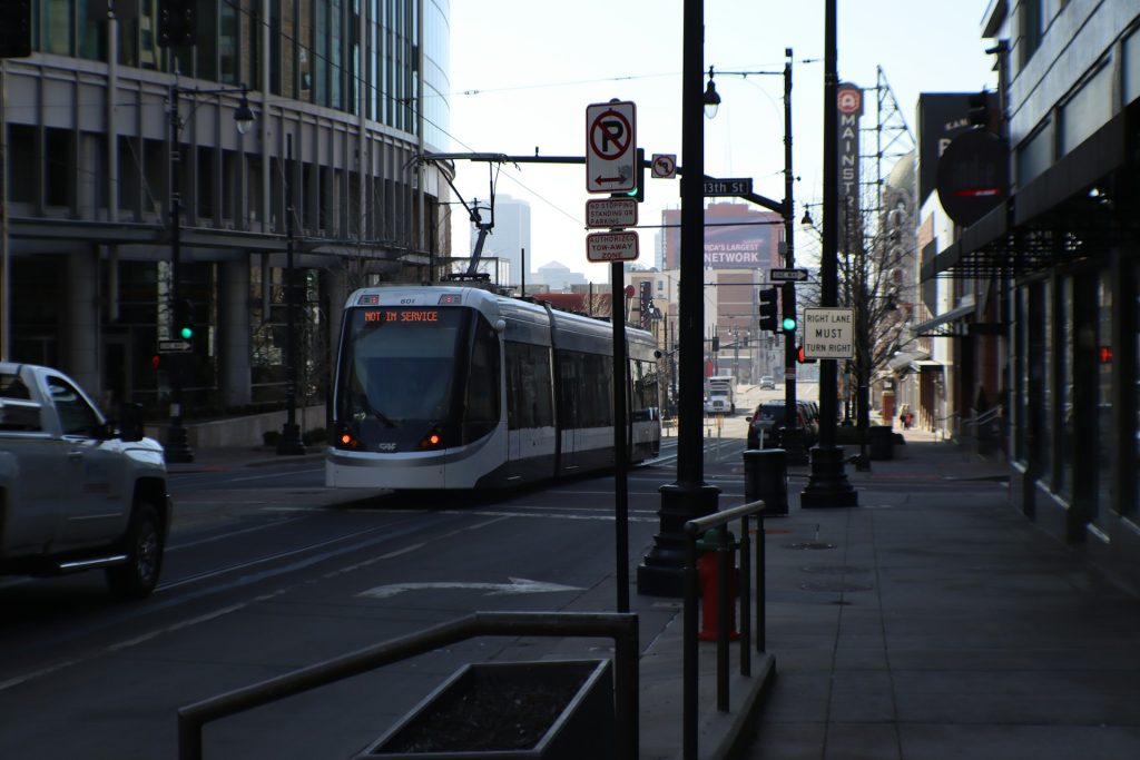 Kansas City streetcar on Main Street with no-parking signs and downtown buildings in the background.