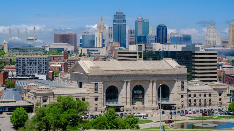 Aerial view of Kansas City's Union Station with its grand facade and the downtown skyline in the background.
