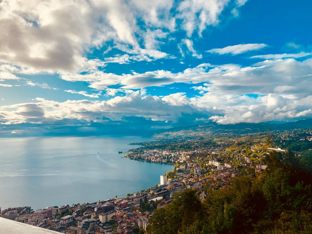 Aerial view of Montreux on Lake Geneva with vineyards, town and dramatic cloudy sky.