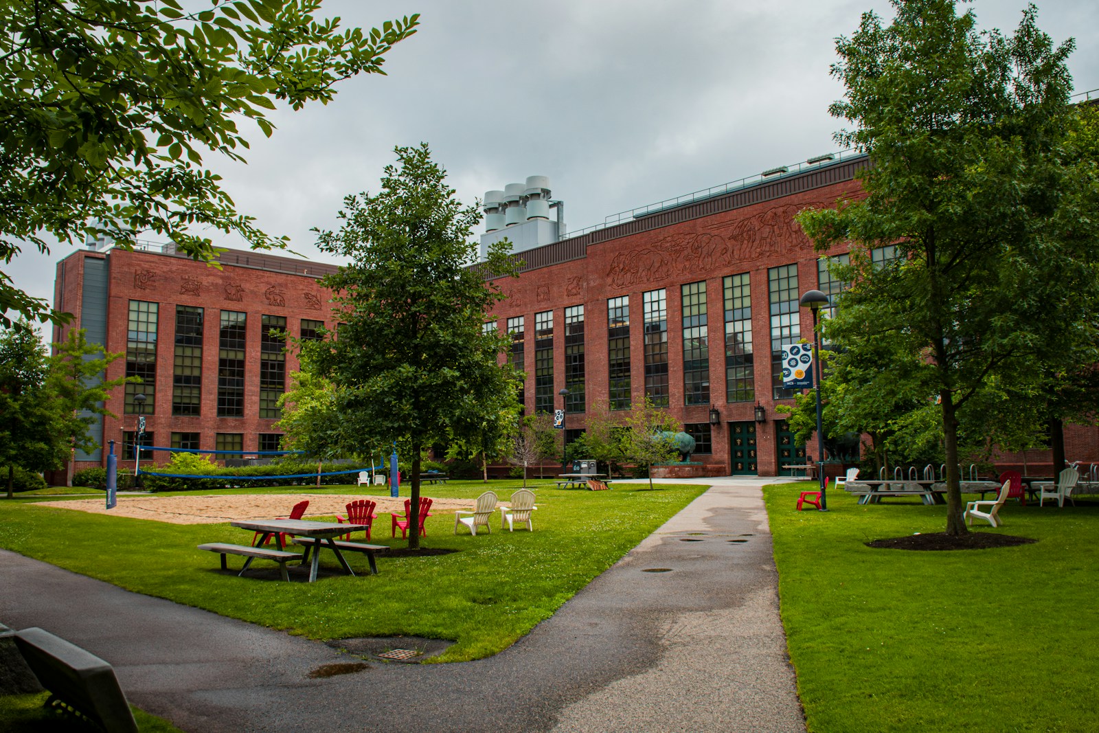 A large brick building with a grassy area in front of it on the Harvard University campus