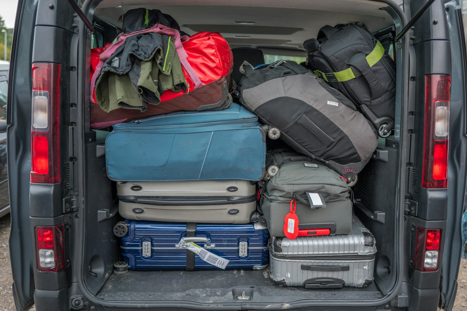 The interior of a van loaded to the roof with luggage and boxes for a trip